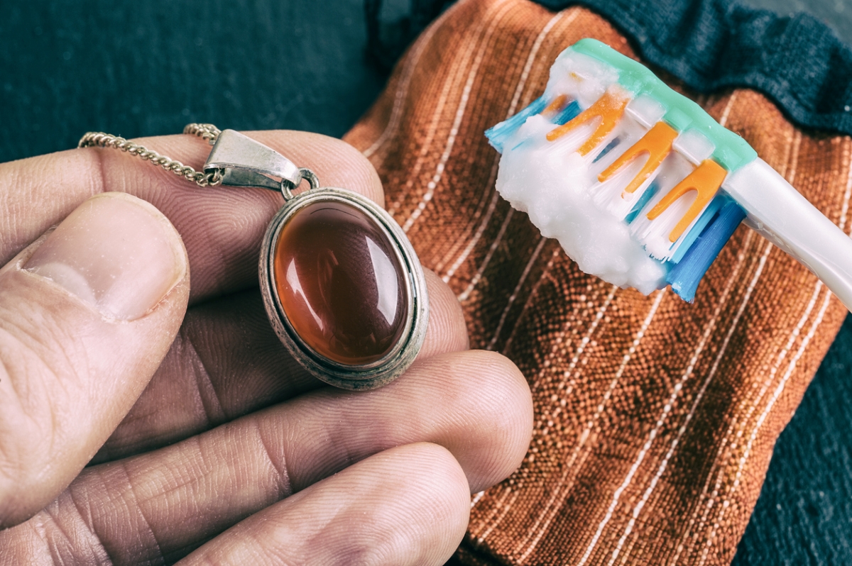 Cleaning brass pendant with toothbrush