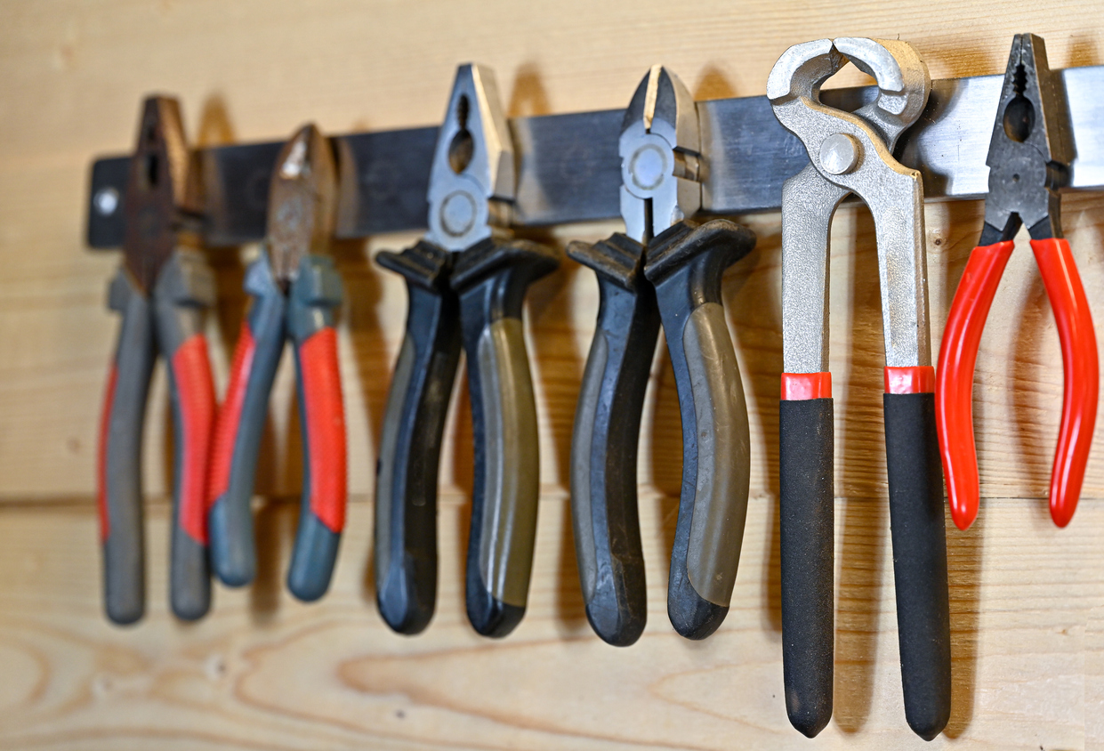 https://www.bobvila.com/wp-content/uploads/2013/07/iStock-1370323000-Types-of-Pliers-Various-pliers-hanging-on-a-magnetic-strip-on-a-wall.jpg