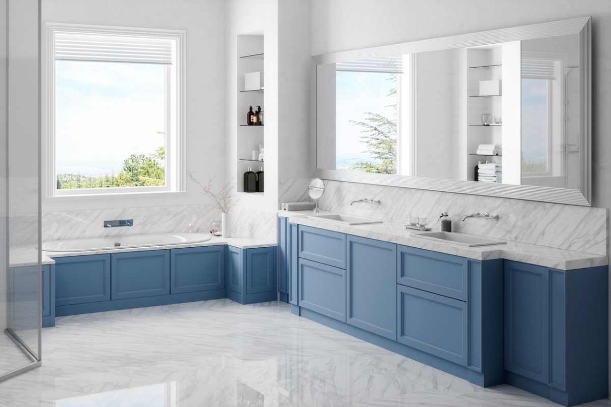 A modern bathroom with blue cabinets and ample tile flooring.