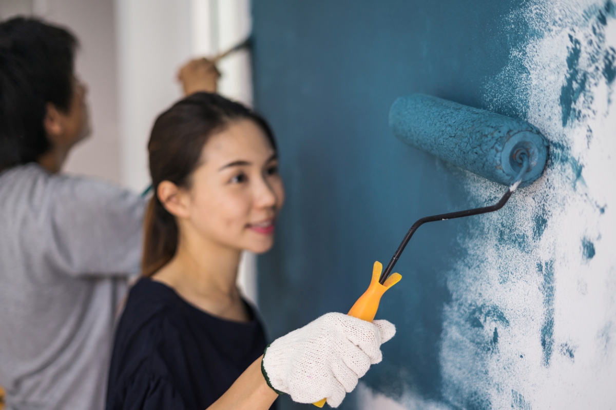 Woman painting wall