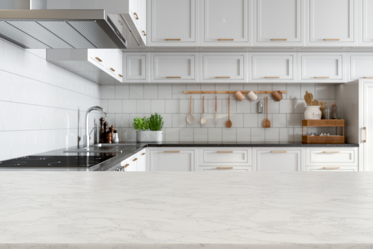 A white marble kitchen countertop in a white kitchen