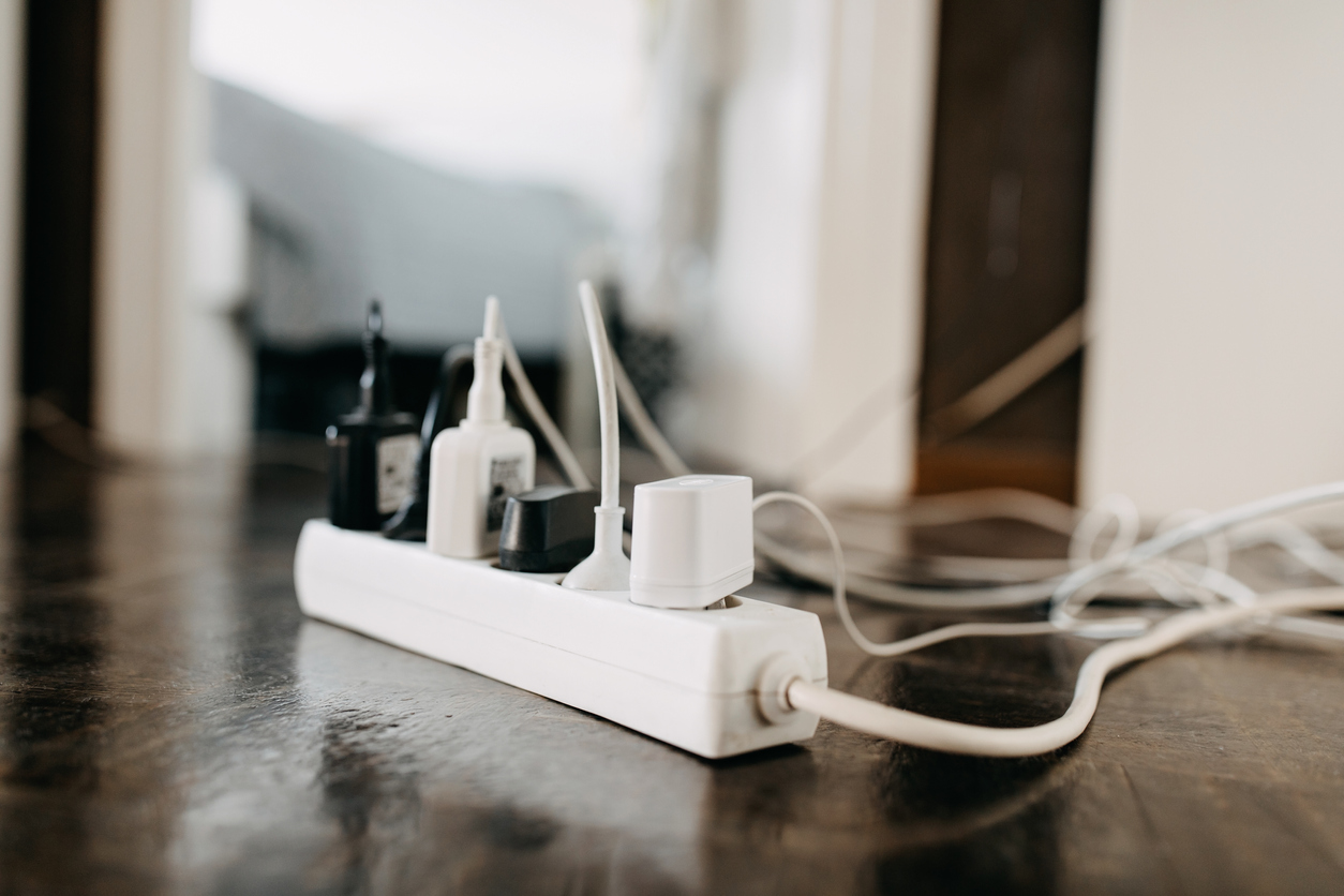 power strip with too many cords on floor