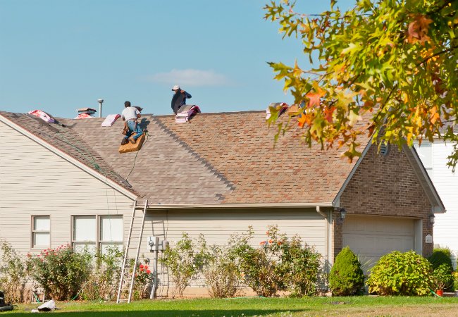 Roof contractors at work on a sunny day.