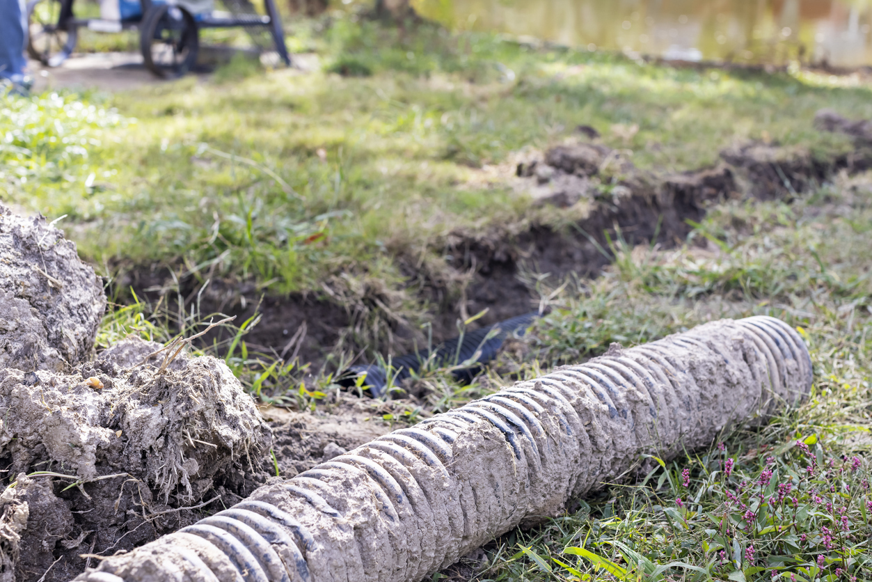 Trench dug in backyard to install French Drain