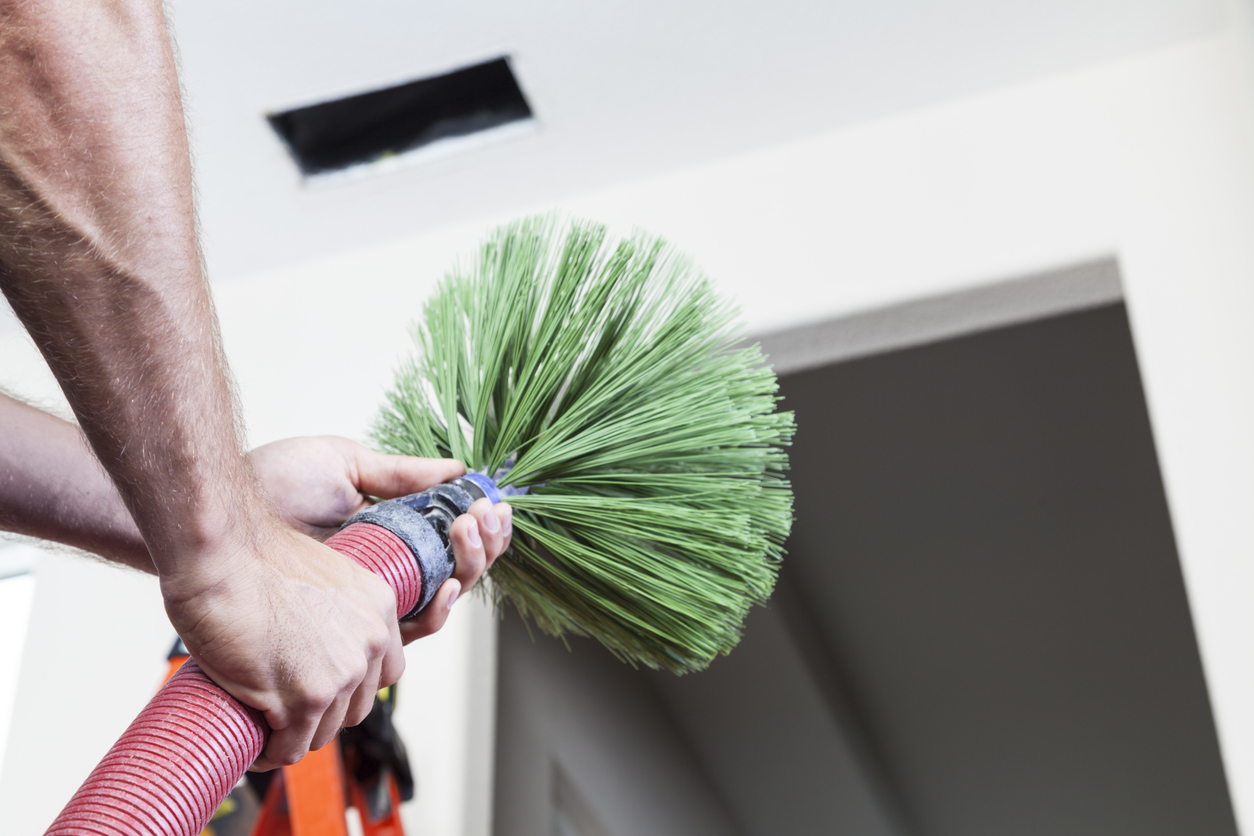 Man cleaning air ducts in home.