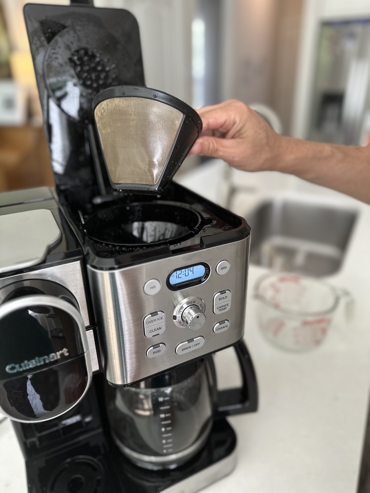 Removing the filter before cleaning a coffee maker