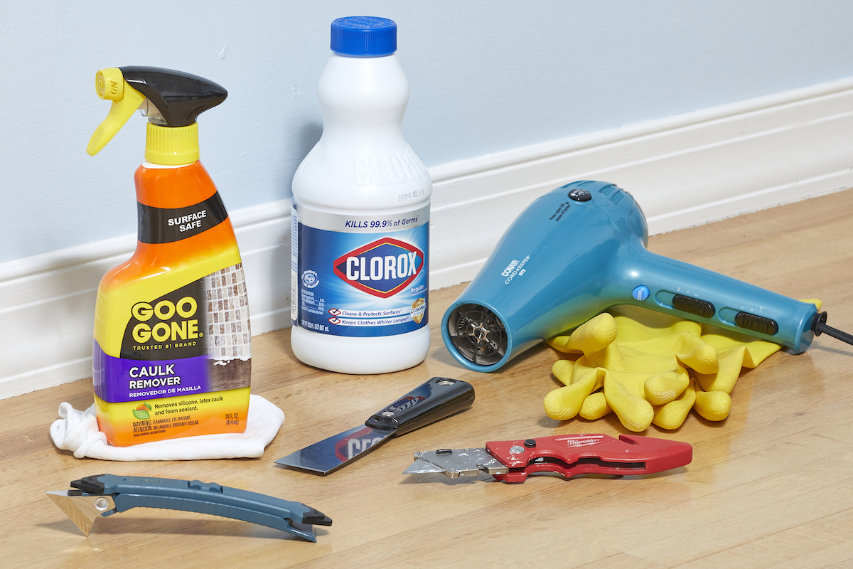 Materials needed for removing caulk, including: Goo Gone, bleach, hair dryer, and more.