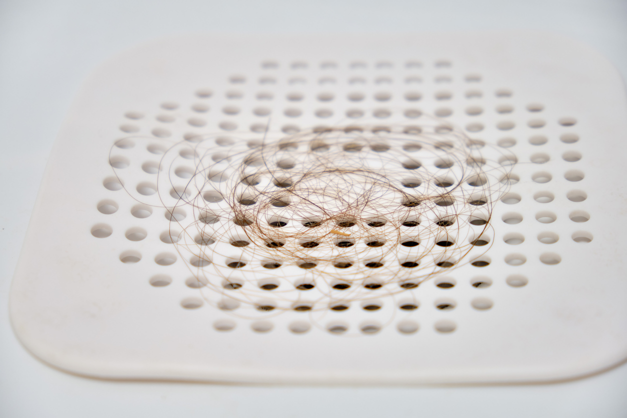 Hair on the plastic trap grate when draining water in the sink