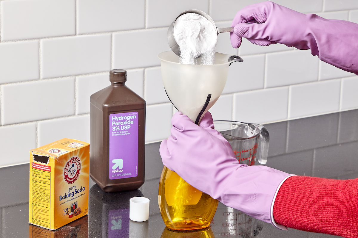 Woman mixes baking soda and peroxide in homemade grout cleaner recipe.