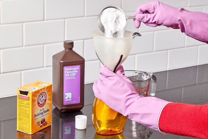 Woman mixes baking soda and peroxide in homemade grout cleaner recipe.