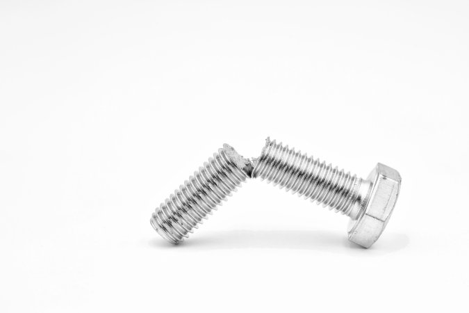 A broken screw on a white background.