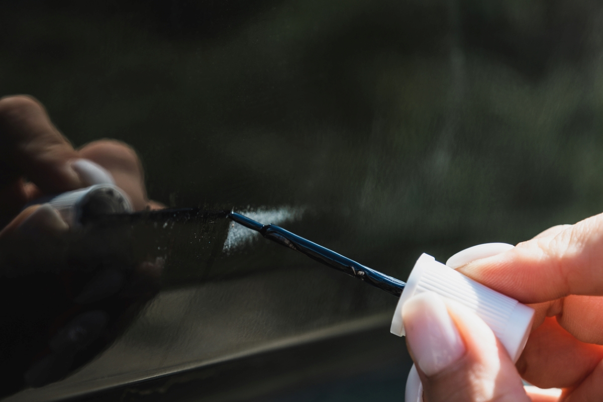 Using clear nail polish on glass scratches.