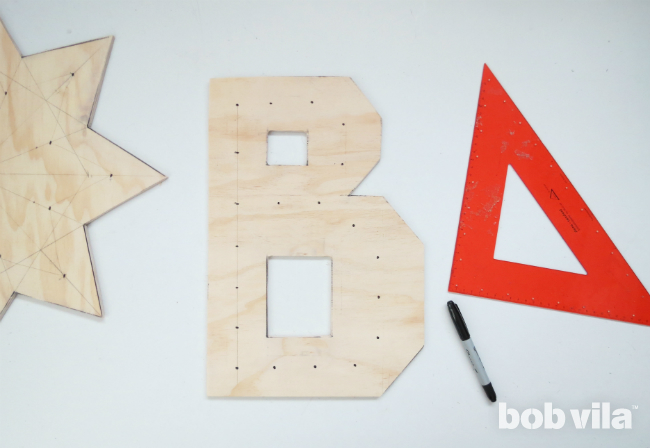 "B" marquee letter has spots for light bulbs identified and marked.