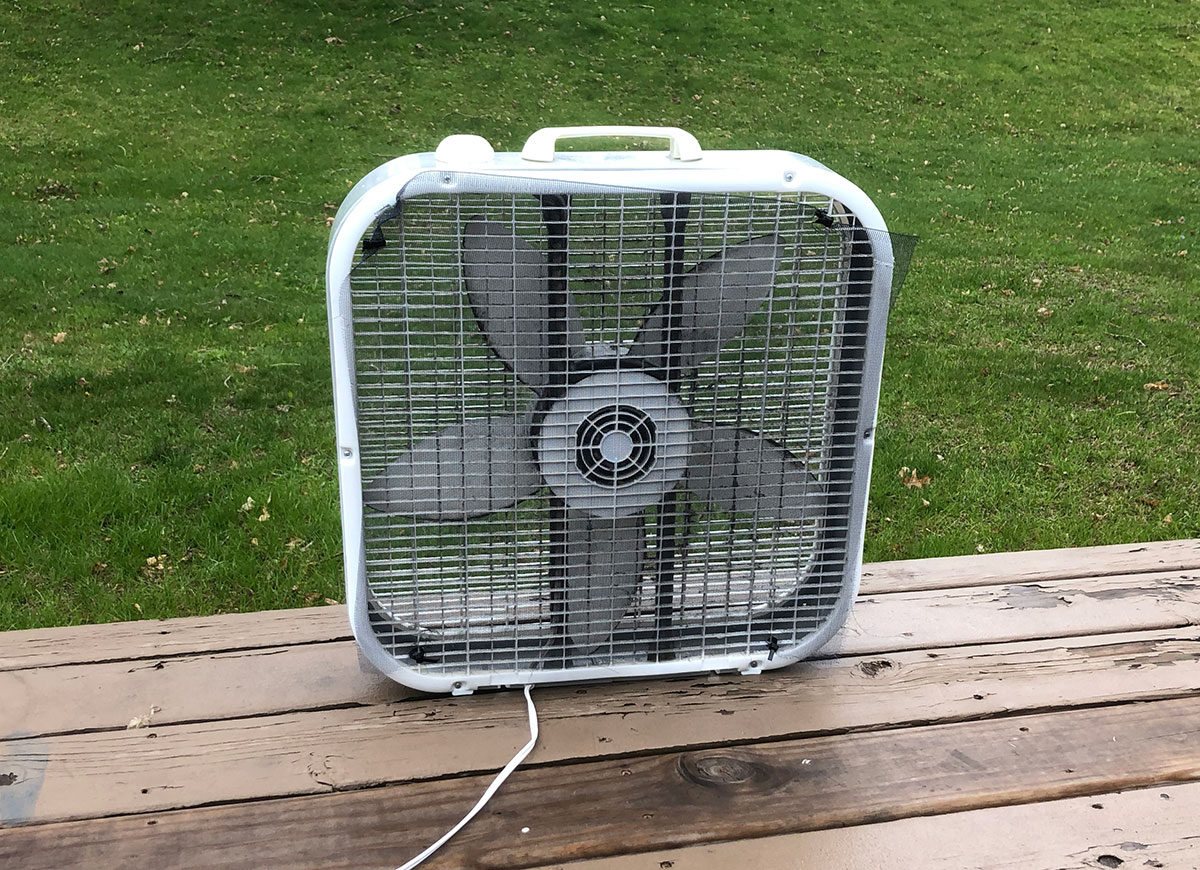 A DIY mosquito trap using box fan and window screen.