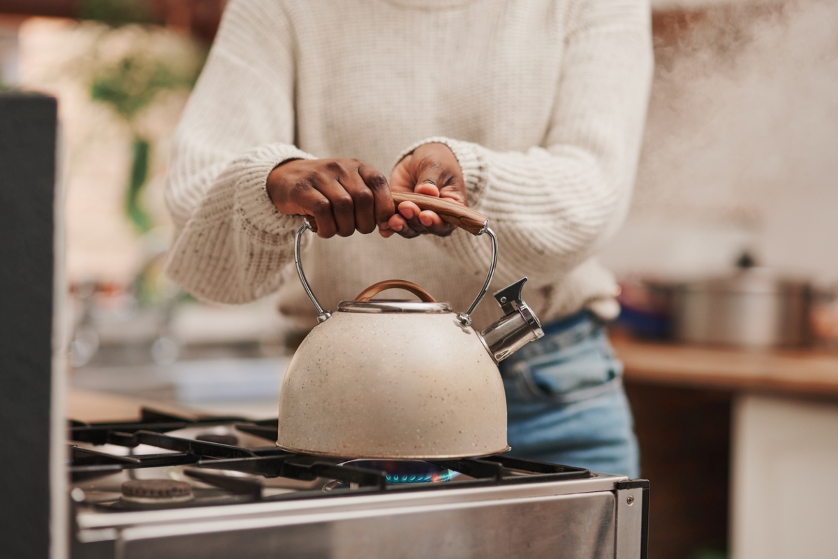 how to descale a kettle - woman holding kettle