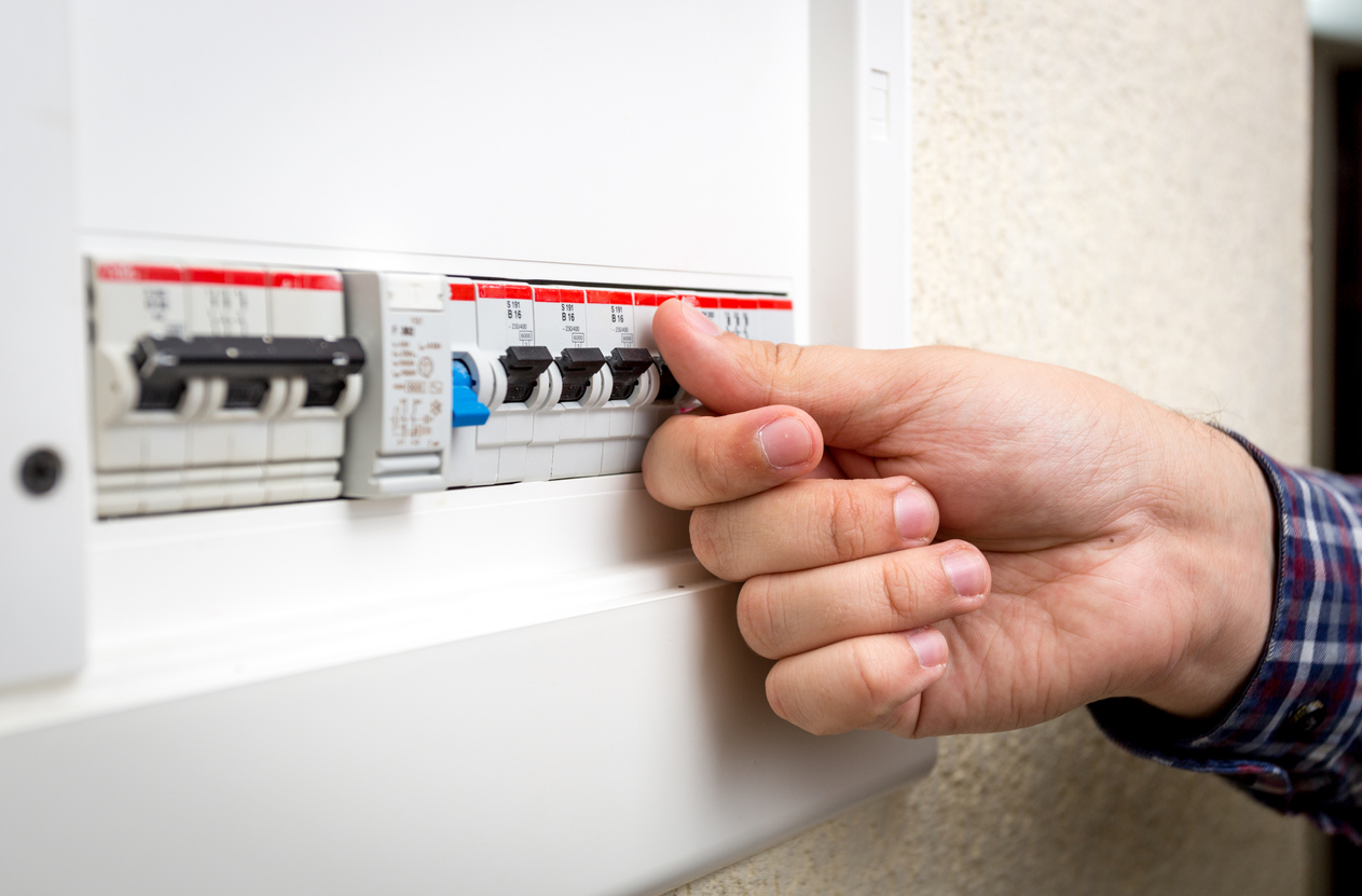 Closeup shot of man switching on fuseboard