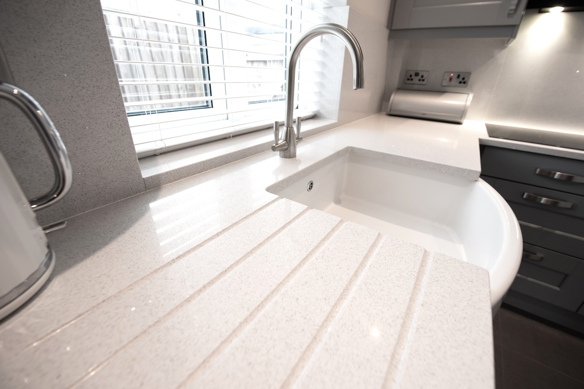 White quartz countertop in a modern kitchen.