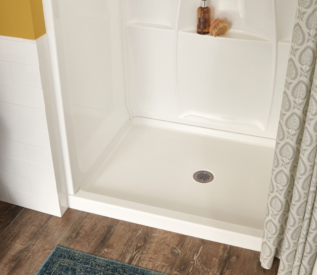 White shower pan in bathroom shower.