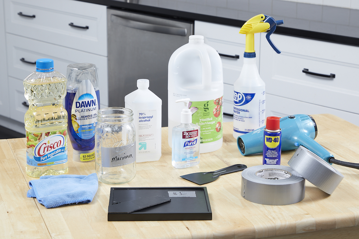 Rolls of duct tape, duct taped items, and cleaning materials laid on a counter.