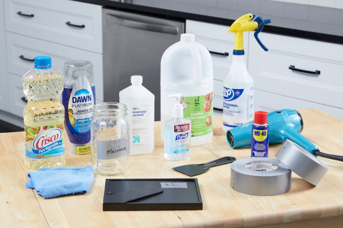 Rolls of duct tape, duct taped items, and cleaning materials laid on a counter.