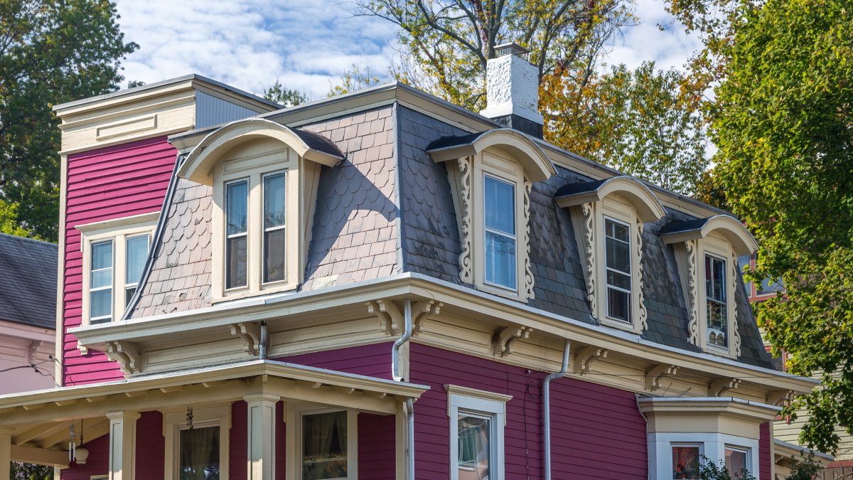 Colorful, Victorian-style house with bonnet dormers.