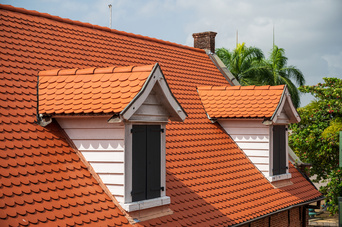 Dutch-style building with red roof and blind dormers in Suriname.