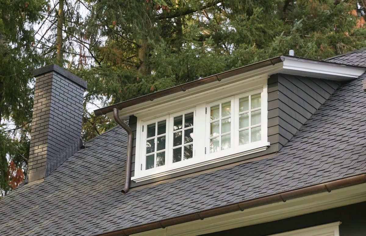 Shed dormer on a house with a grey shingled roof.