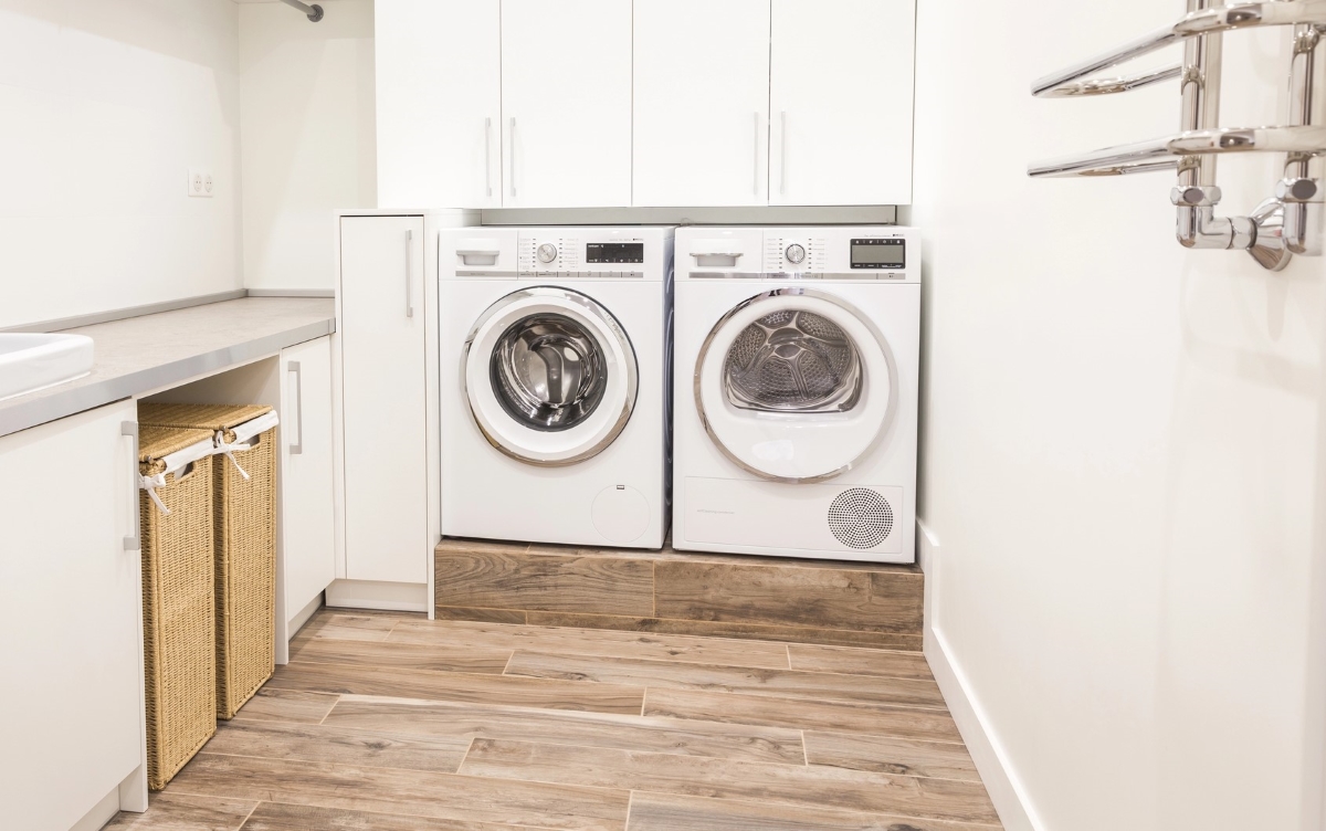 Modern laundry room with luxury vinyl flooring.