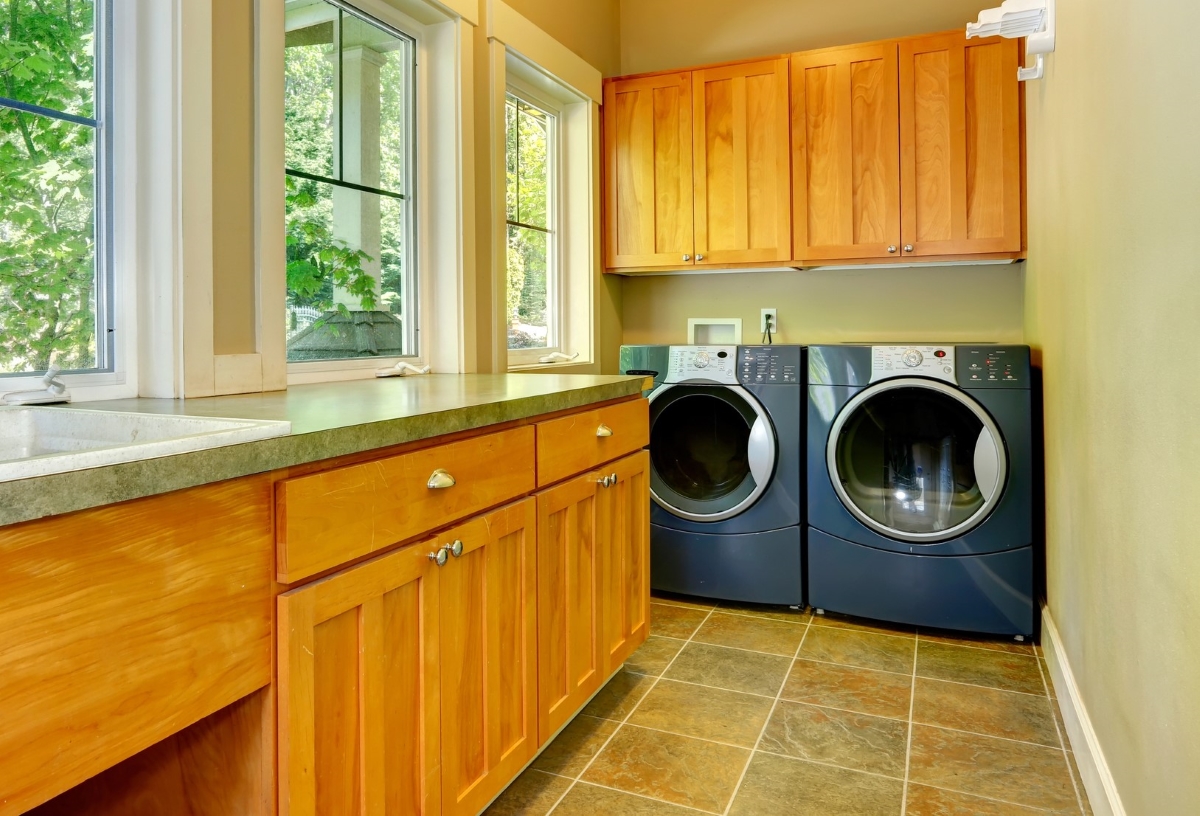 Modern laundry room with ceramic tile flooring.