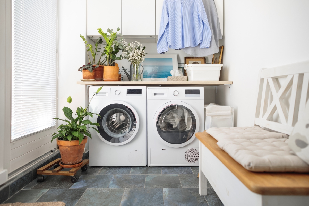 Laundry room with stone tile flooring.