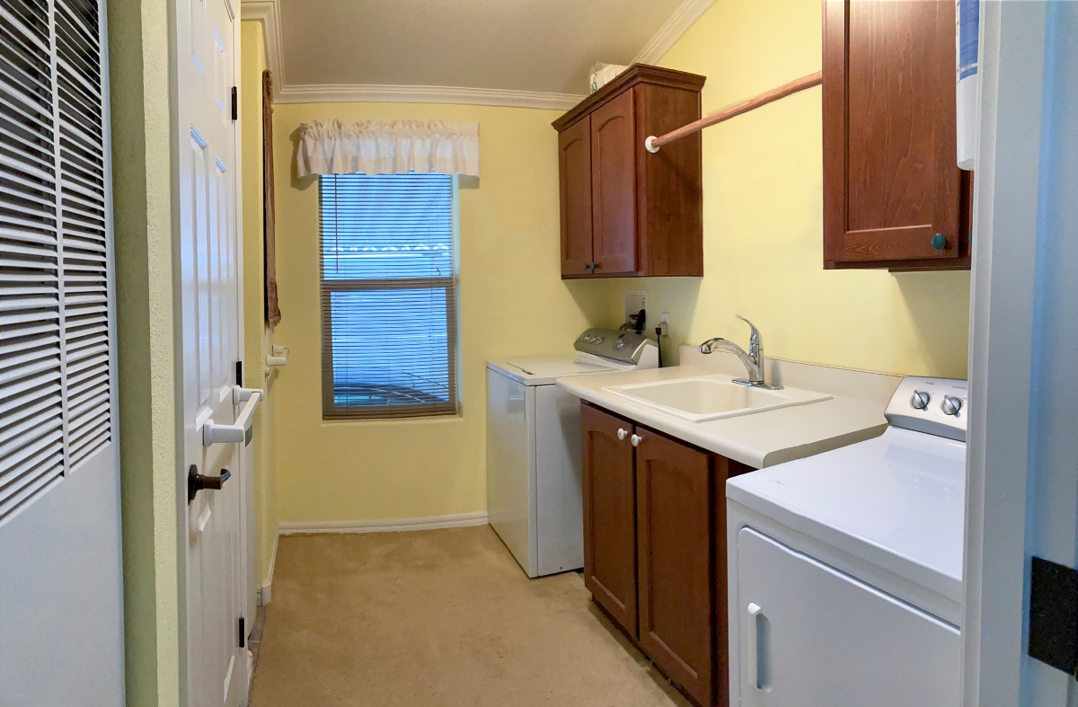 Laundry room with carpet flooring.