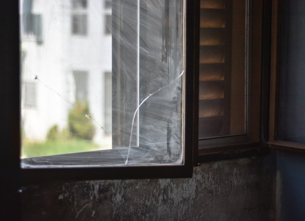 A broken window and decayed wall.