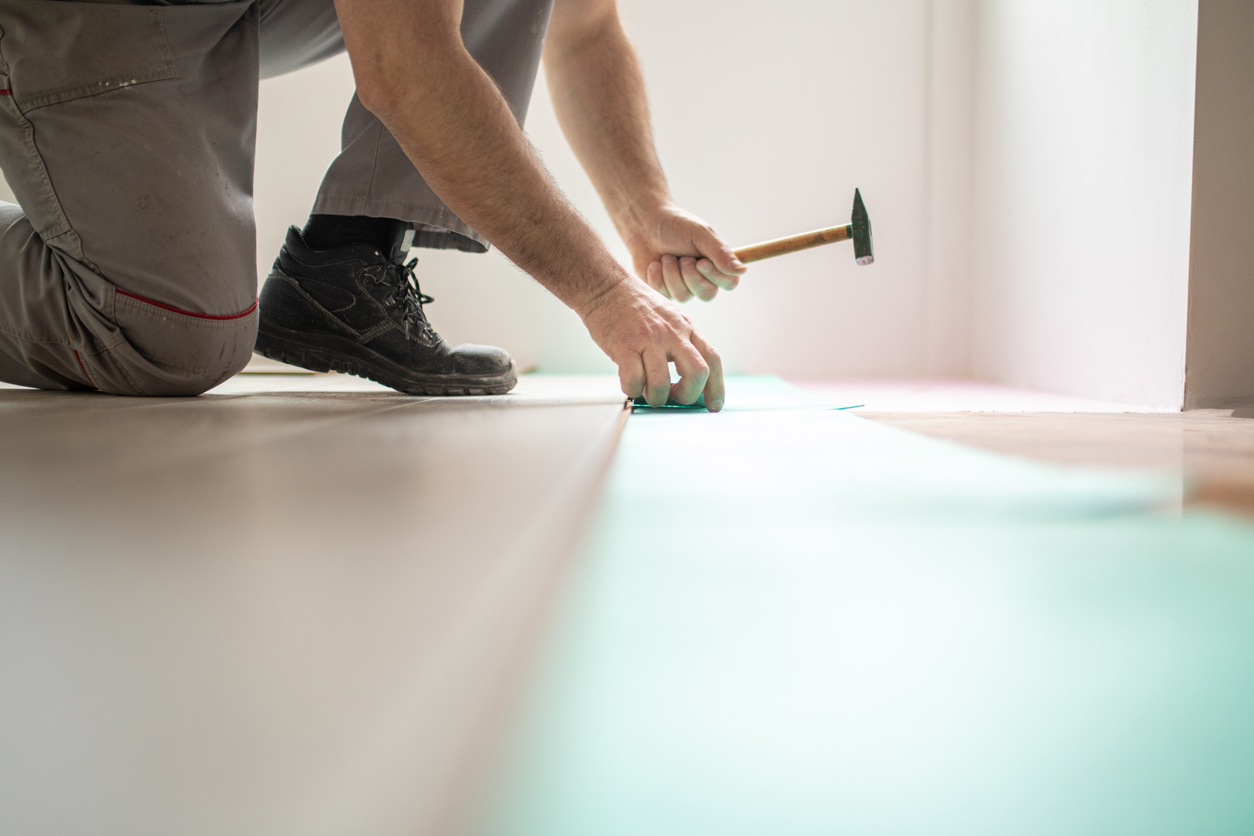 Man Installing New Laminate Wood Flooring