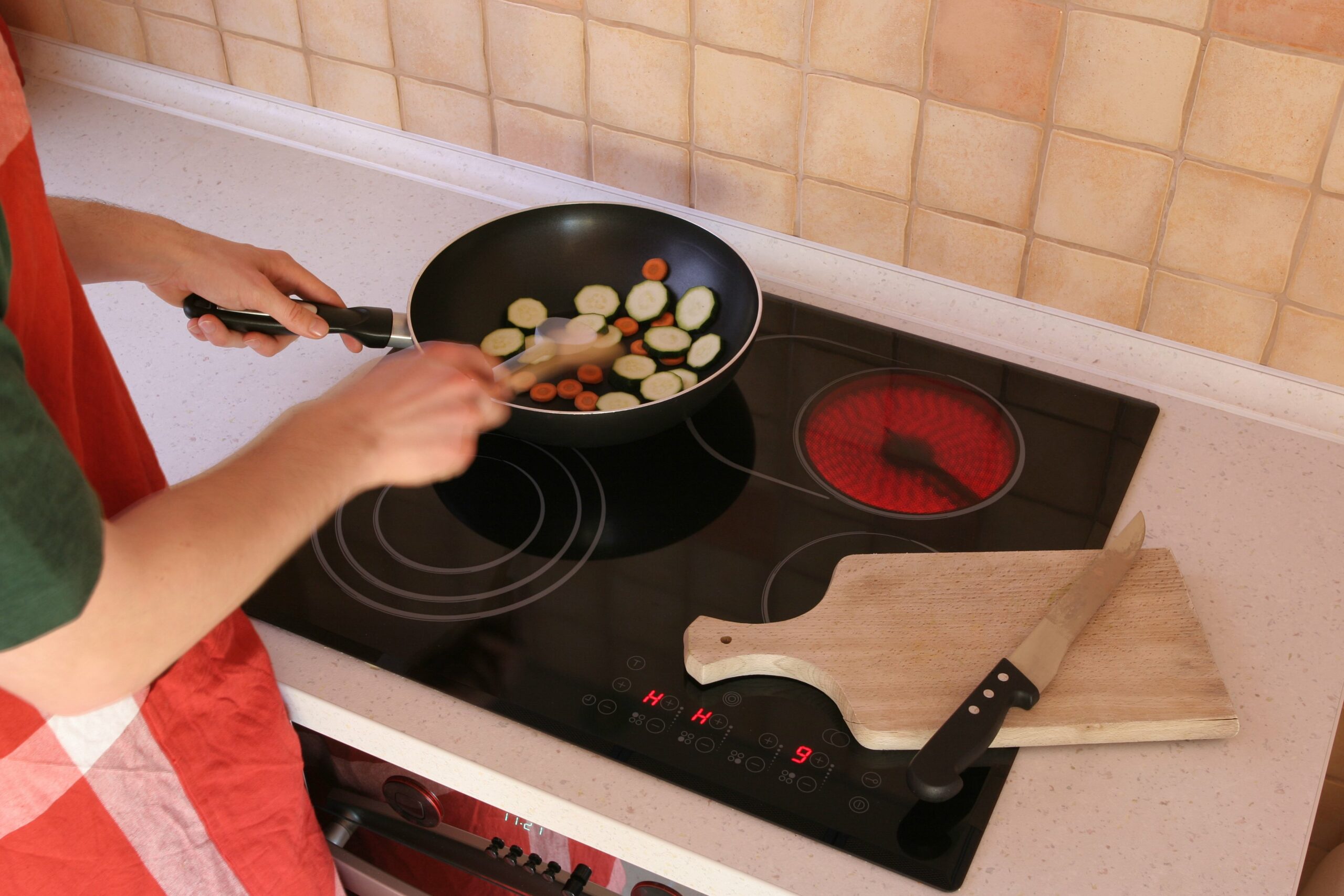 Man preparing vegetables with motion blur from fast mixing.