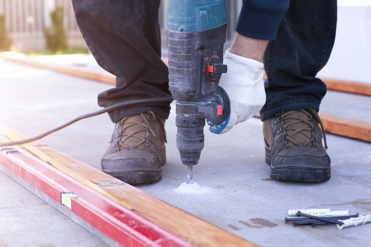 hammer drill drilling hole in concrete