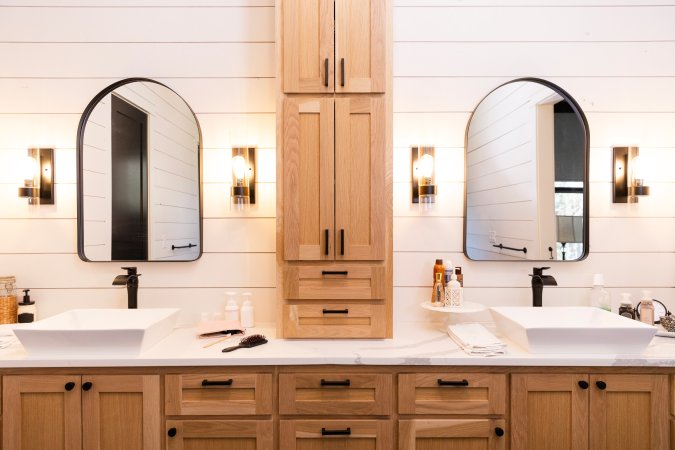 Photo of a recently renovated modern bathroom with shiplap walls and natural wood cabinetry in a family home.