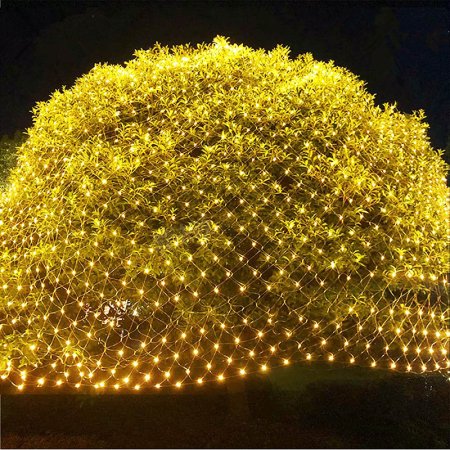  The Twinkle Star 360 LED Christmas Net Lights installed on a bush and lit up at night.