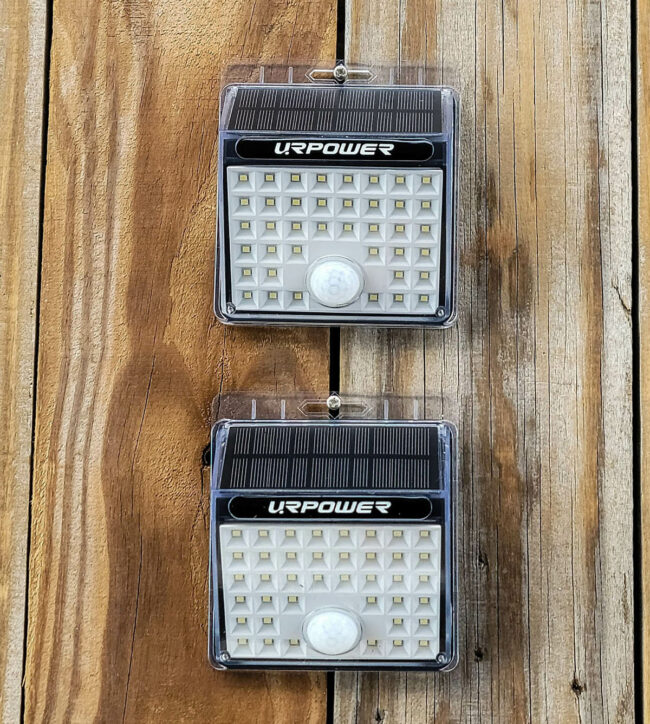 Two motion sensor lights laying on wood.