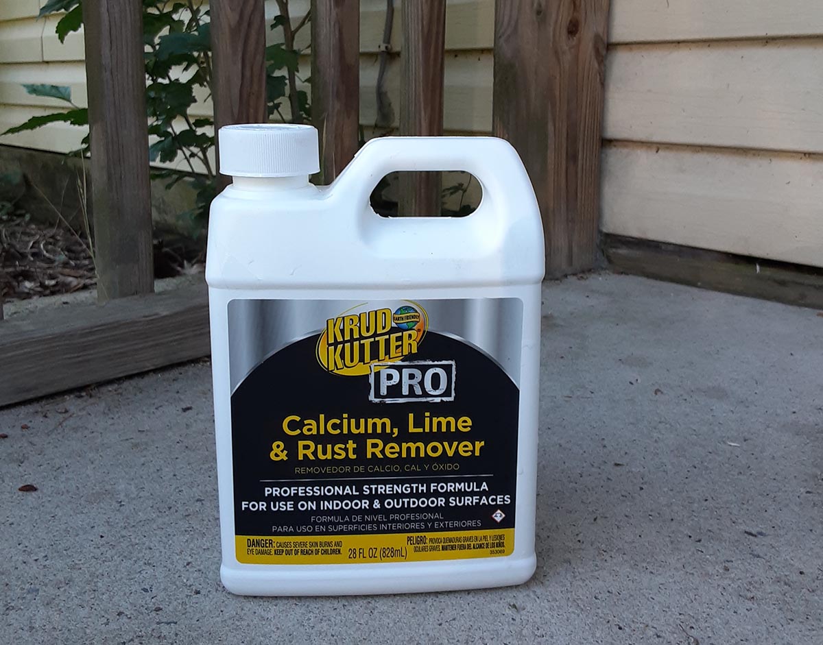 Bottle of Krud Kutter Pro vinyl siding cleaner on concrete porch