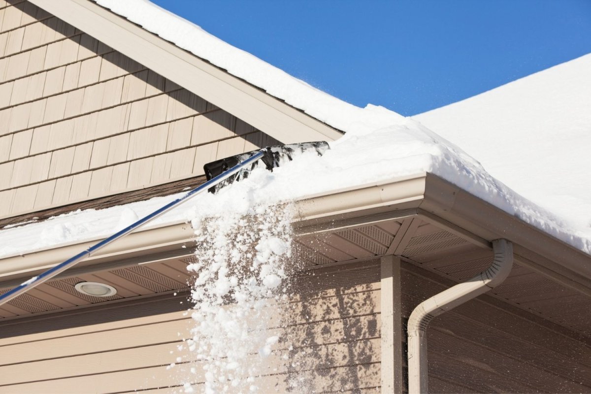 The best roof rake option in action pulling snow off a roof.