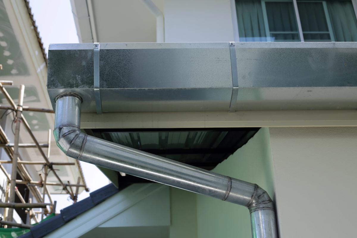 Stainless steel roof gutters on a residential multifamily building.