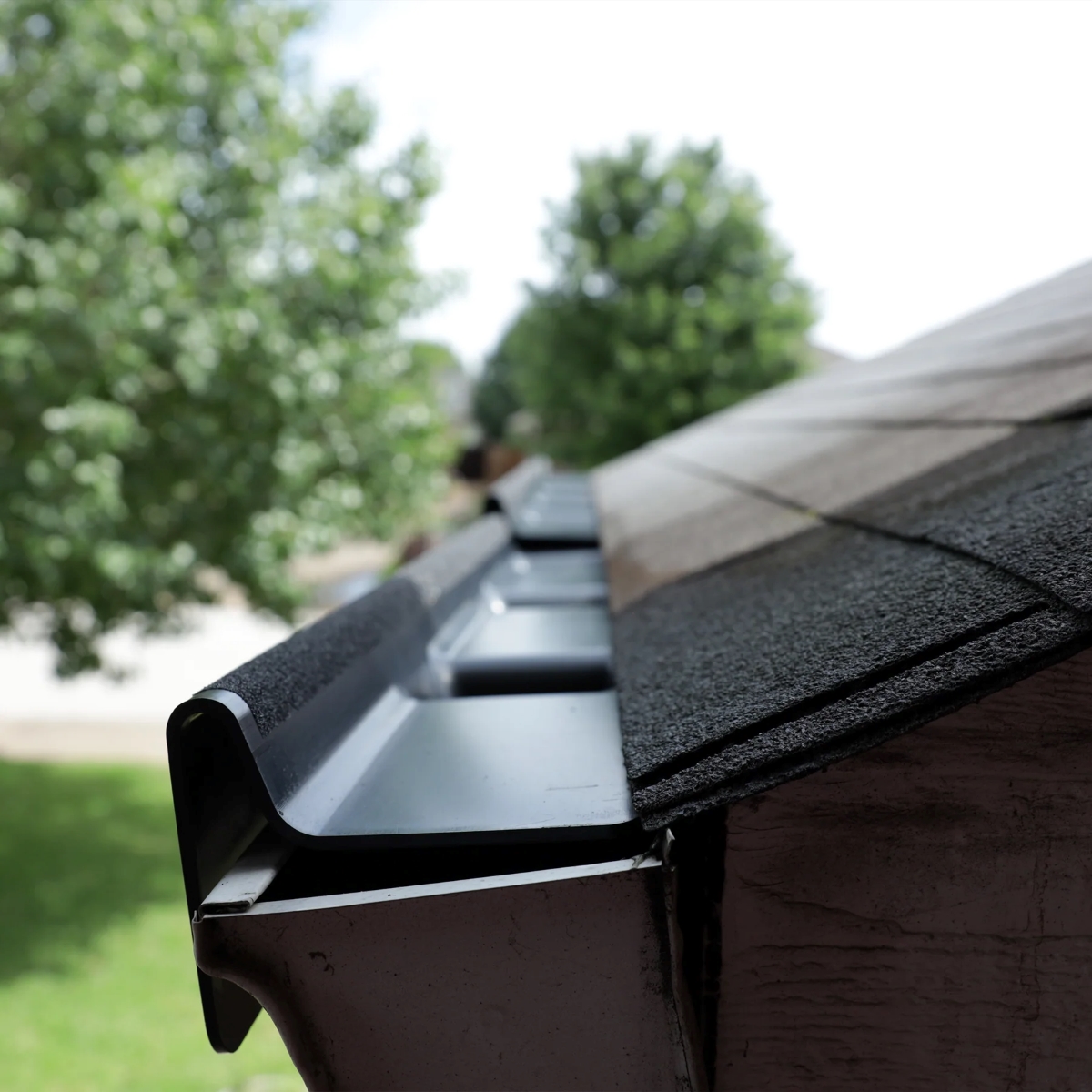 A close view of a installed gutter apron on roof.