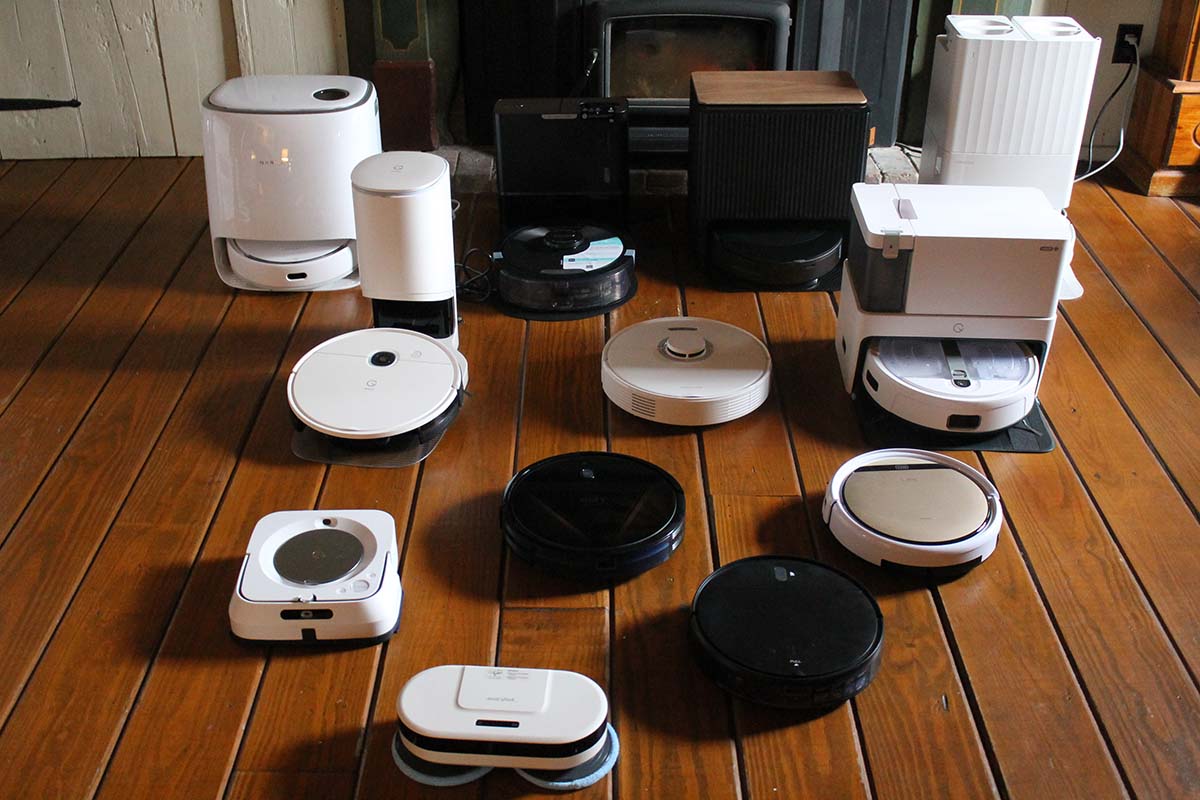 Several robot mops lined up on hardwood floor