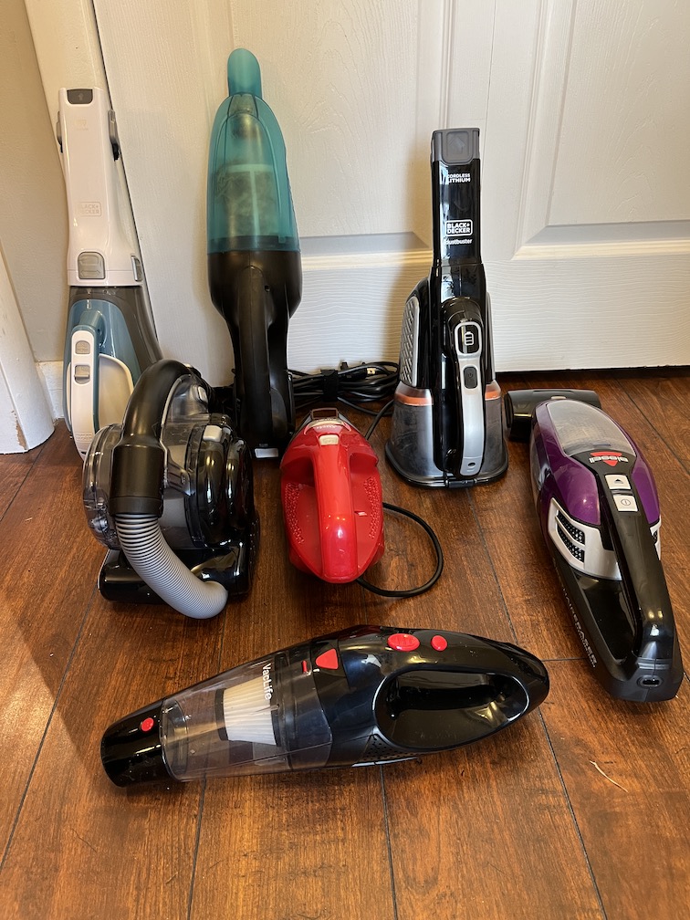 The Best Handheld Vacuum Options laid out on the floor inside a room