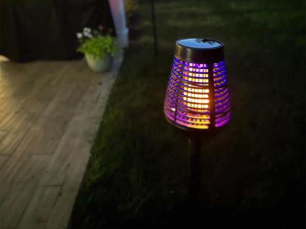 The best bug zapper option glowing next to a porch