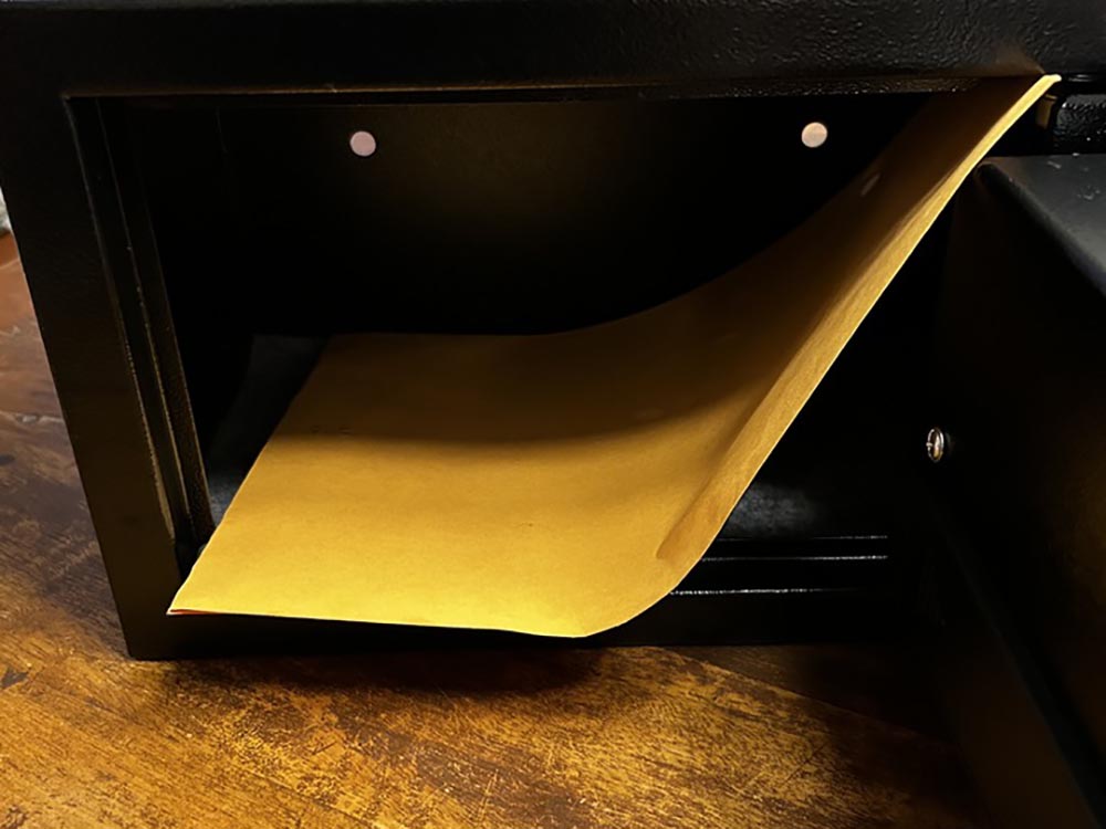 Large yellow envelope inside a black Stalwart home safe