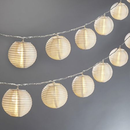  LampLust Mini Lantern String Lights against a grey wall