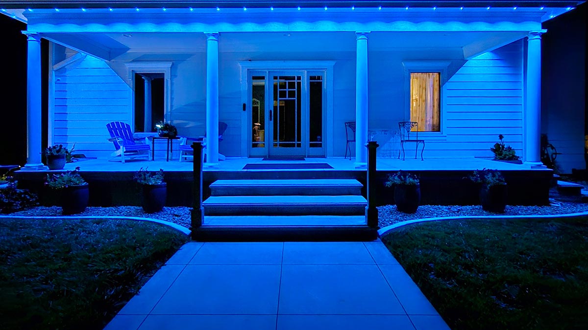 Blue Outdoor String Lights hung on the eaves of a front porch