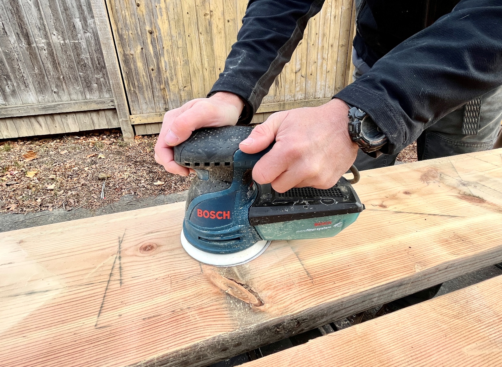 Man working with one of the Best Palm Sander Options