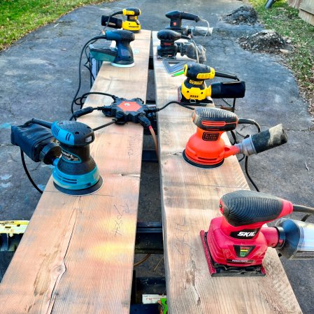 The Best Palm Sander Options laid on a bench